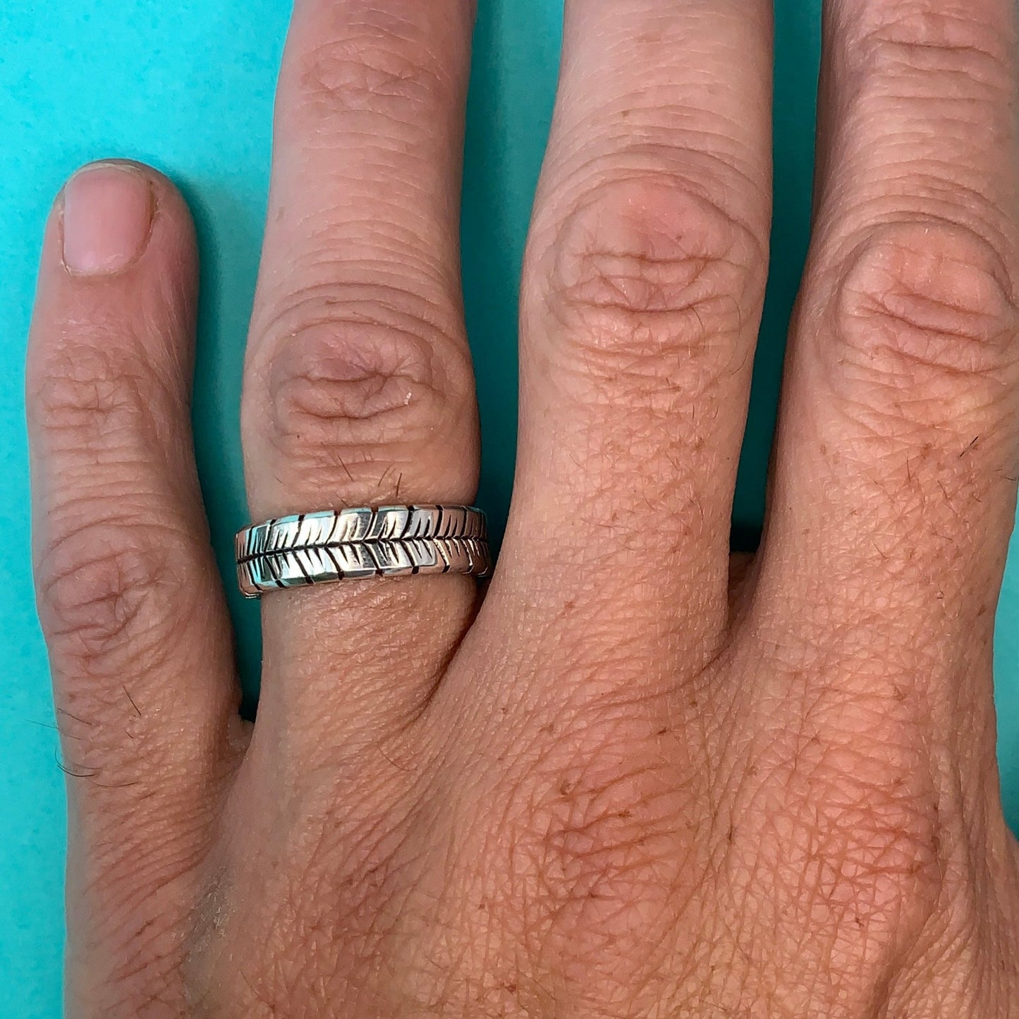 feather ring on hand